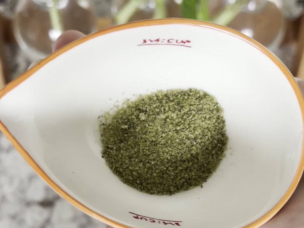 Fine green basil salt in a small bowl.